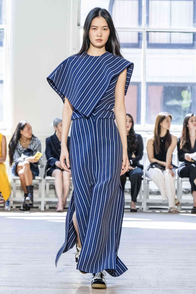 model wearing blue striped romper with white lines